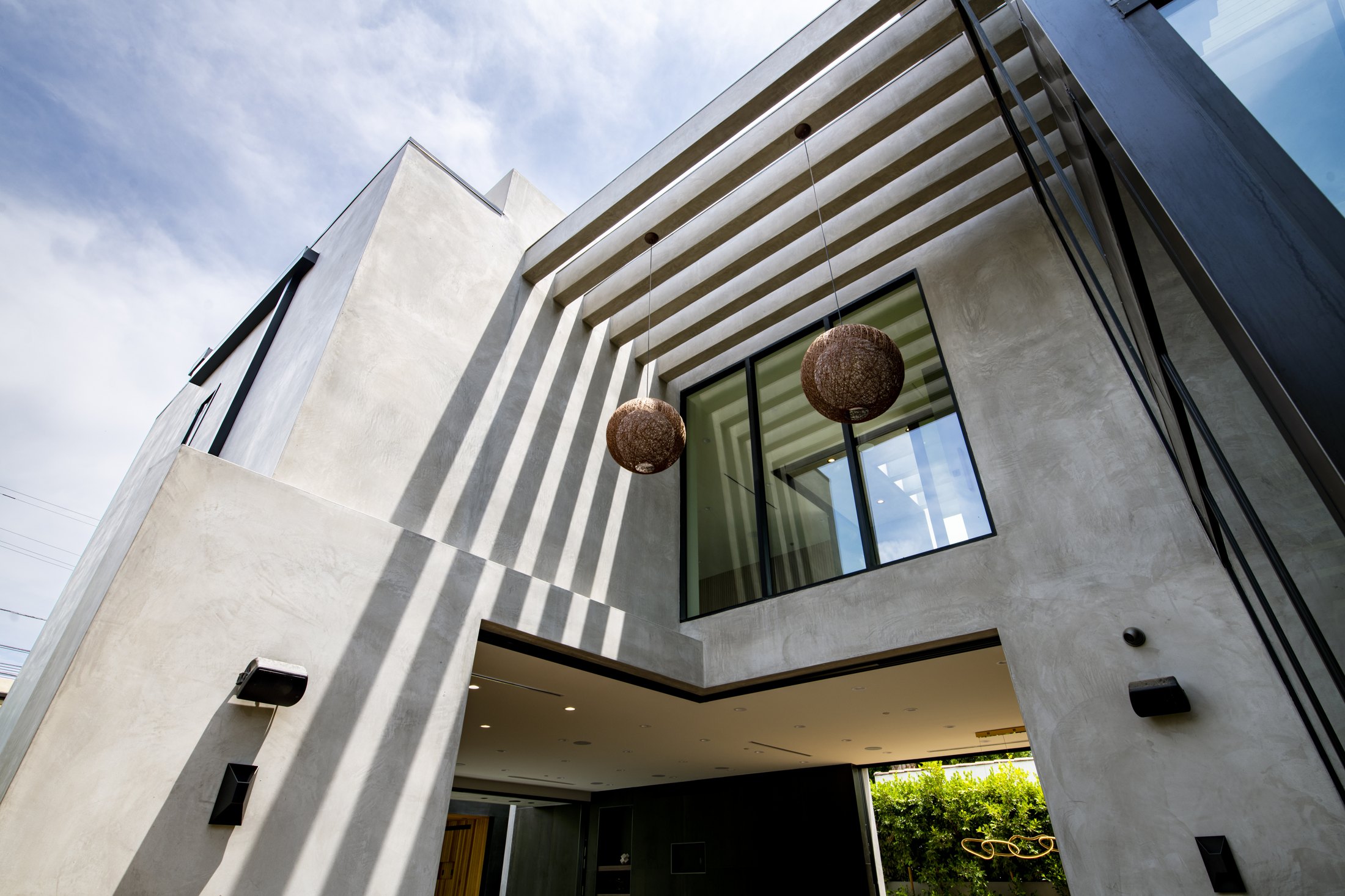 Sculpted exterior details and pendant lighting at Casa De Flor
